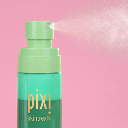 Pixi Skintreats Antioxidant Mist bottle with a light green pump spraying a fine mist against a solid pink background. view 2