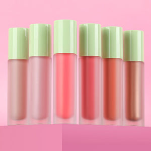 Set of six LiquidGlow products with green caps on a pink background