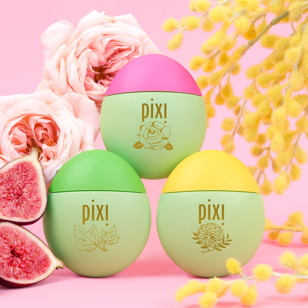 HandHero Hand Lotion Fragrance trio featuring PixiRose, PixiMimosa and PixiFig shown on a pink background with roses, mimosa blooms and figs front view.