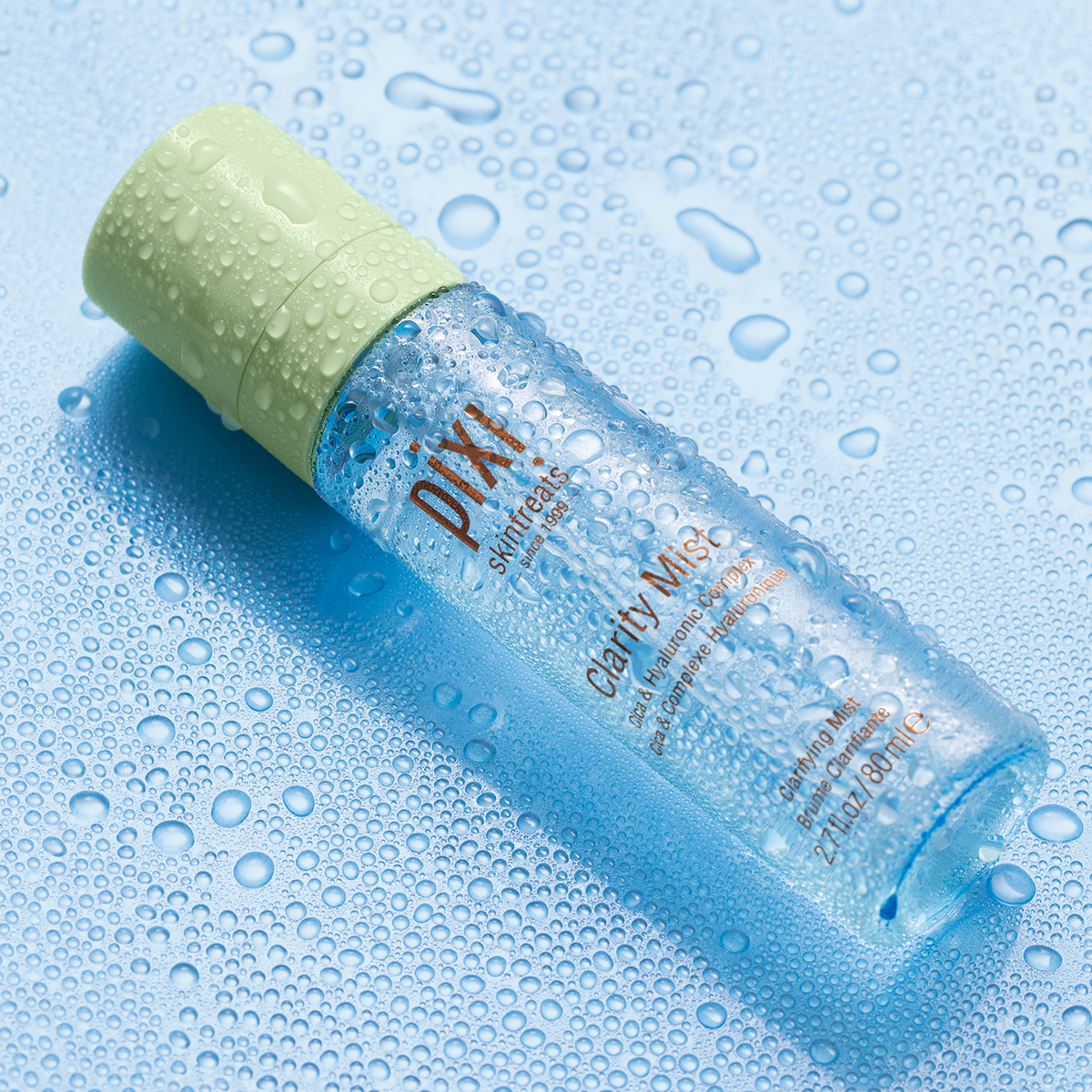Clarity Mist shown on a blue background with water droplets