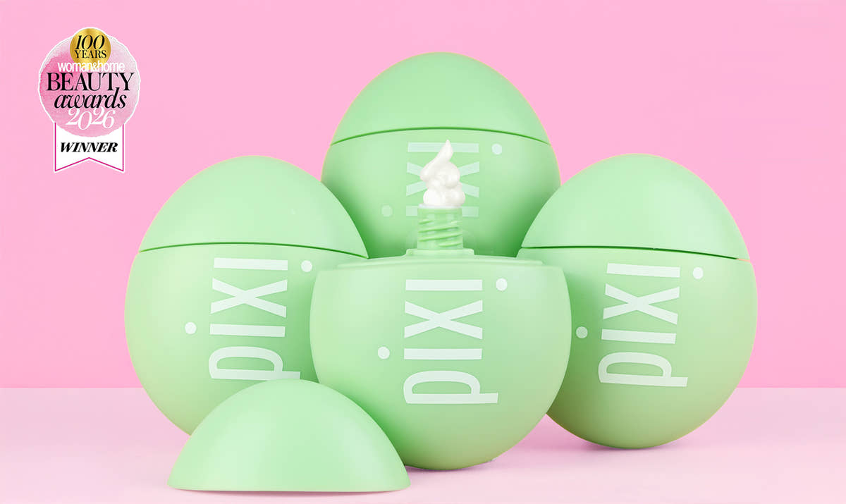 Five light green Pixi cosmetic egg-shaped containers arranged on a pink background, with one open egg showing a white cream product and a Pixi Beauty Awards Winner badge in the top left corner.